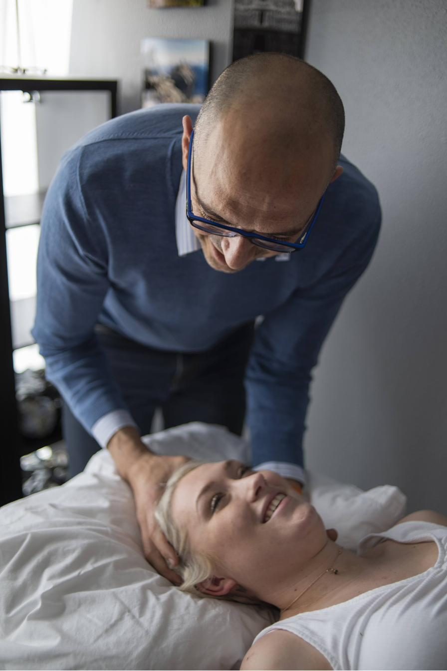 Rajesh Khemraj treating a patient's neck during a clinical session